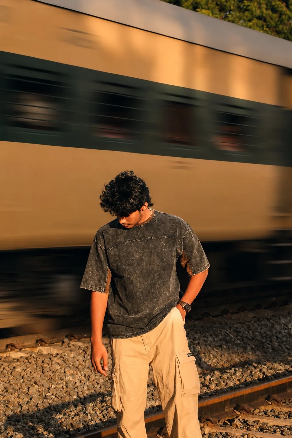 The ORIGIN tee by the railway tracks at golden hour